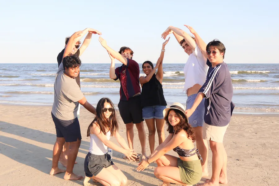 RiceApps members forming an arch with their arms
